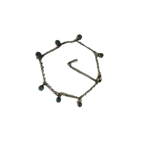 silver-toned bracelet featuring a chain design with multiple small, round blue beads.