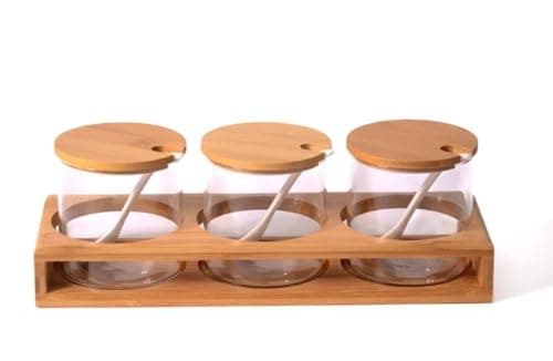 Generic Glass spice set with wooden lids and porcelain spoons on a wooden stand, .flo