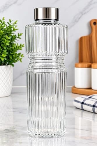 Generic Glass water bottle with a sleek faceted design,Cap: tightly sealed in metallic silver color,Usage: perfect for home, office, or serving juices and water, .am