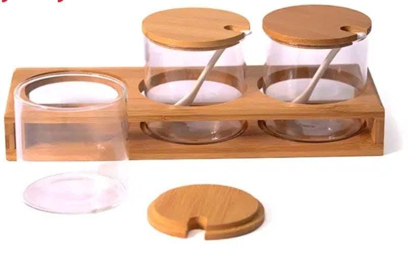 Generic Glass spice set with a wooden lid and a porcelain spoon on a wooden stand, .flo