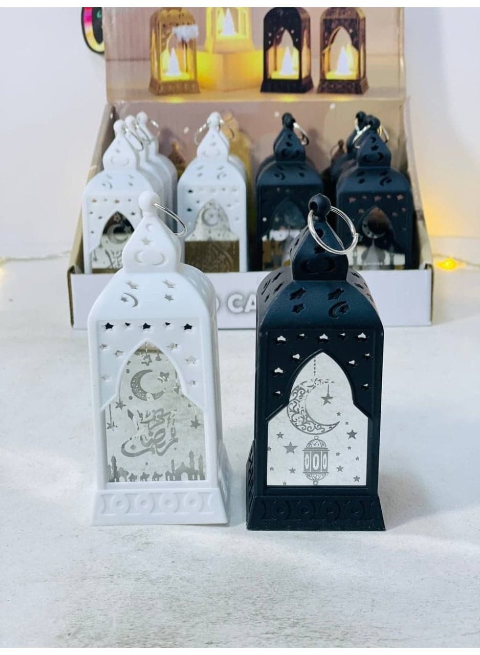 LED Ramadan lantern with glass, featuring Ramadan-themed designs and lights. The lantern is colored and operates on batteries. Size: 12 cm, white, quantity: 1 Candle Lanterns (٣)