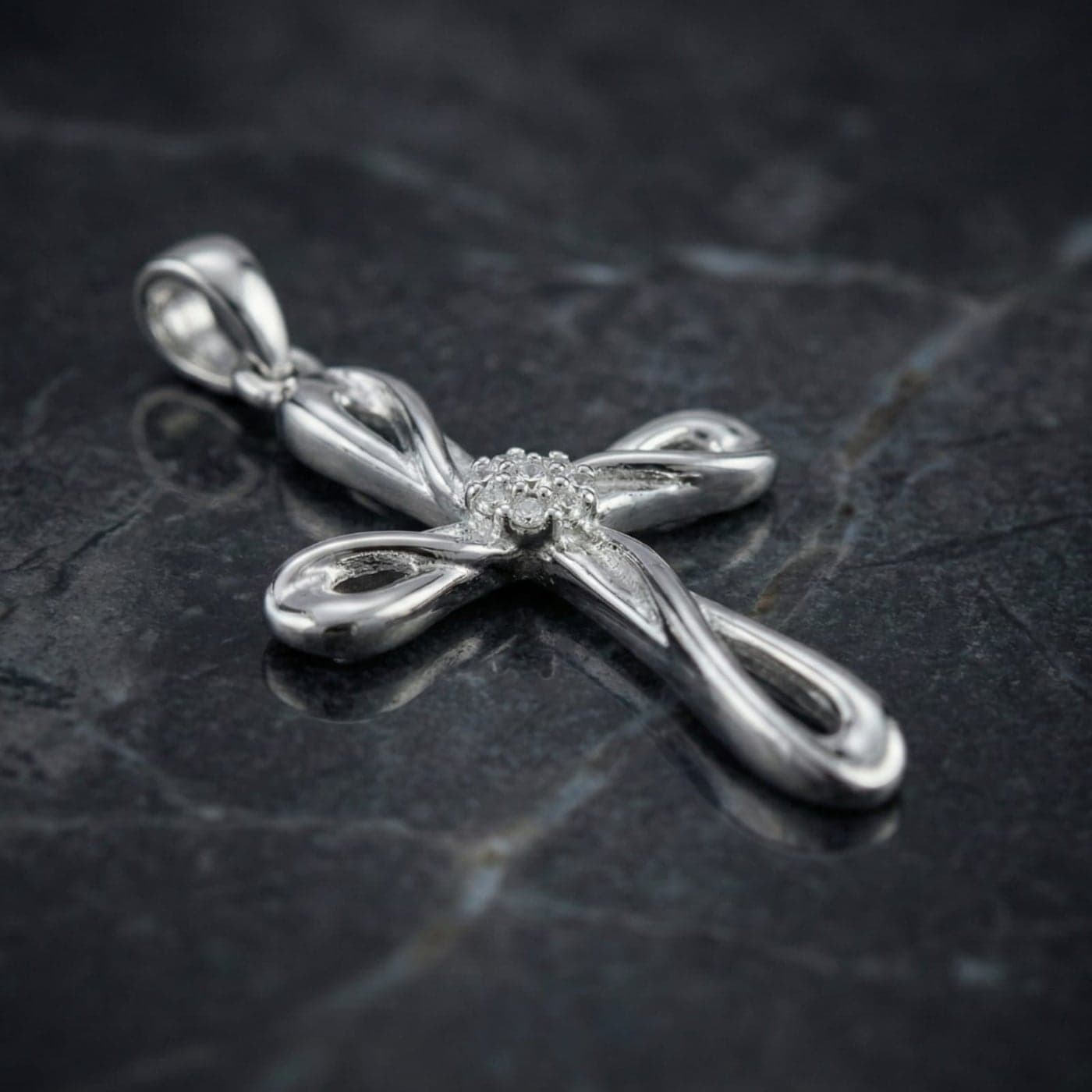 A silver cross pendant (chain not included) with an interlocking infinity design, adorned with sparkling zircon stones in the center. A touch of modern elegance and refined spirituality. Women's Necklaces (7)