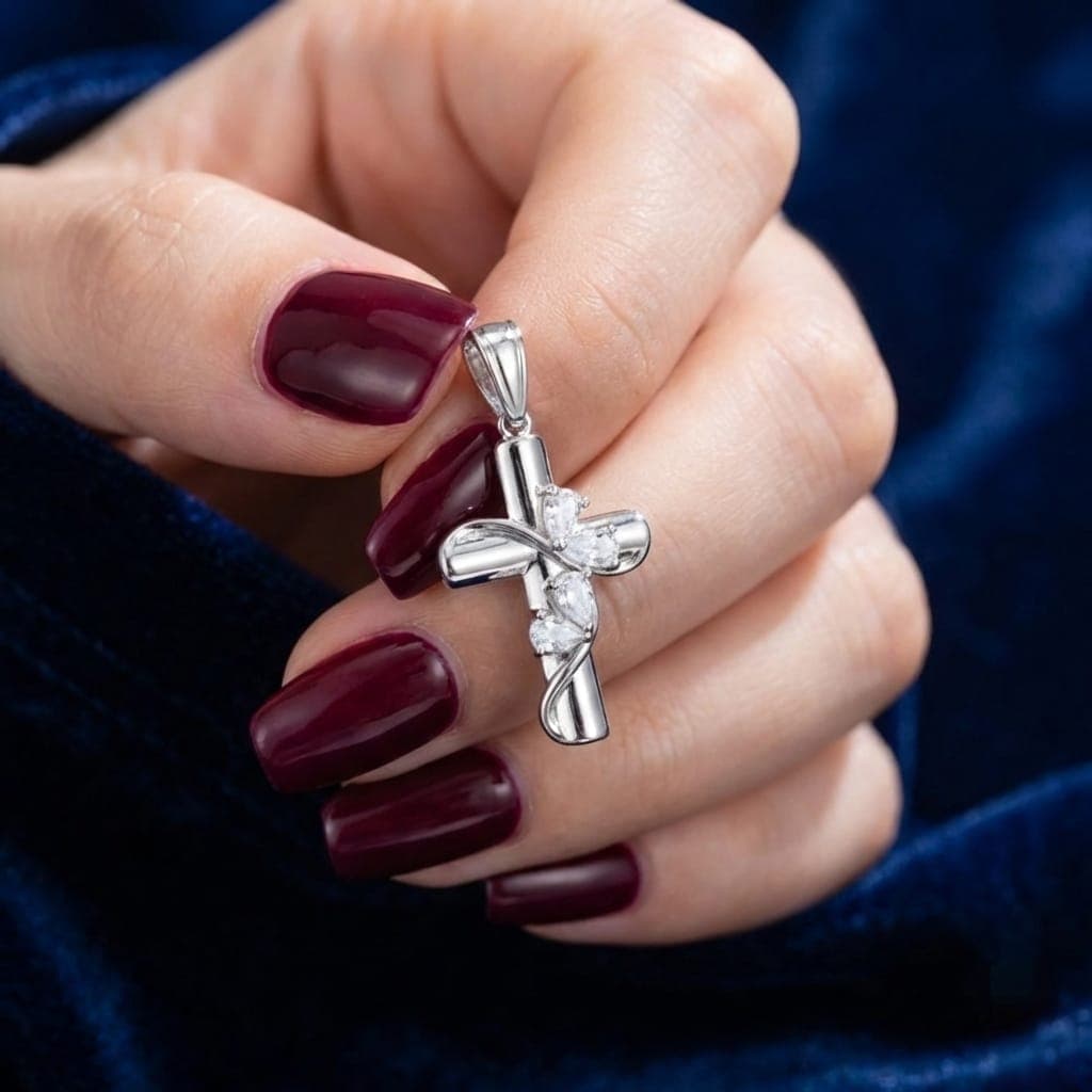 A silver cross pendant (chain not included) with a sleek design, adorned with four sparkling pear-shaped cubic zirconia stones. A sophisticated piece that adds a touch of elegance, beauty, and spirituality to your look. Women's Necklaces (٧)