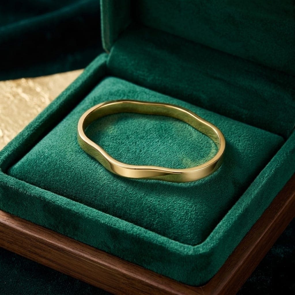 A luxurious bracelet in elegant gold, featuring a unique, flowing, and polished wave design. It adds a touch of modern luxury to your look. An attractive design for any occasion. Women's Bangles (7)