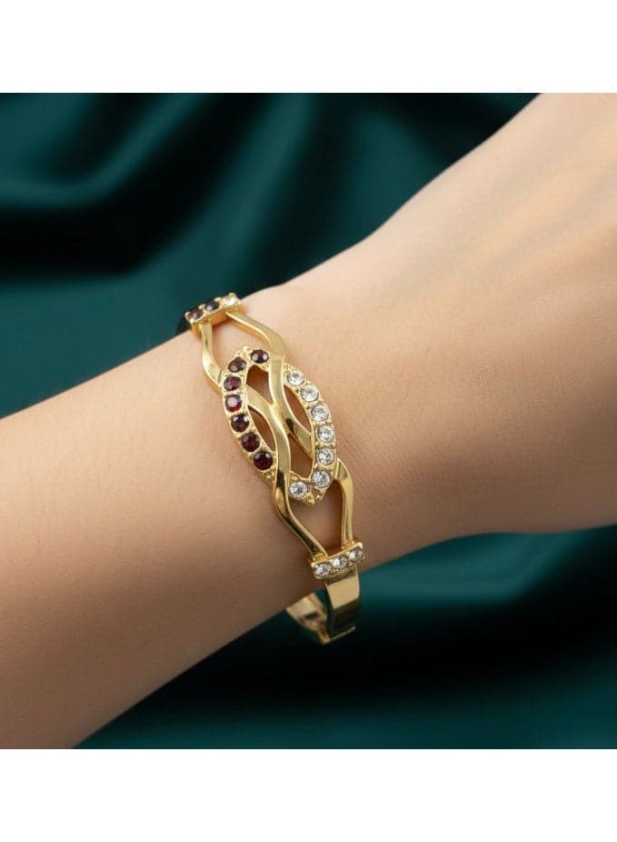 A gold bracelet with a side clasp, featuring a flowing "leaf" design, studded with sparkling zircon stones and elegant brown stones that give your wrist a wonderful look. Women's Bracelets & Bangles