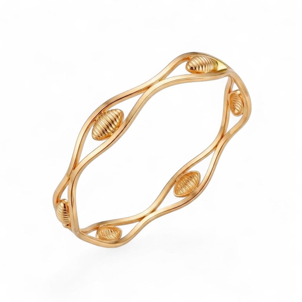 A luxurious bracelet in elegant gold, with a flowing wavy design interspersed with attractive ribbed oval pieces, adding a touch of modern luxury to your look. Women's Bangles