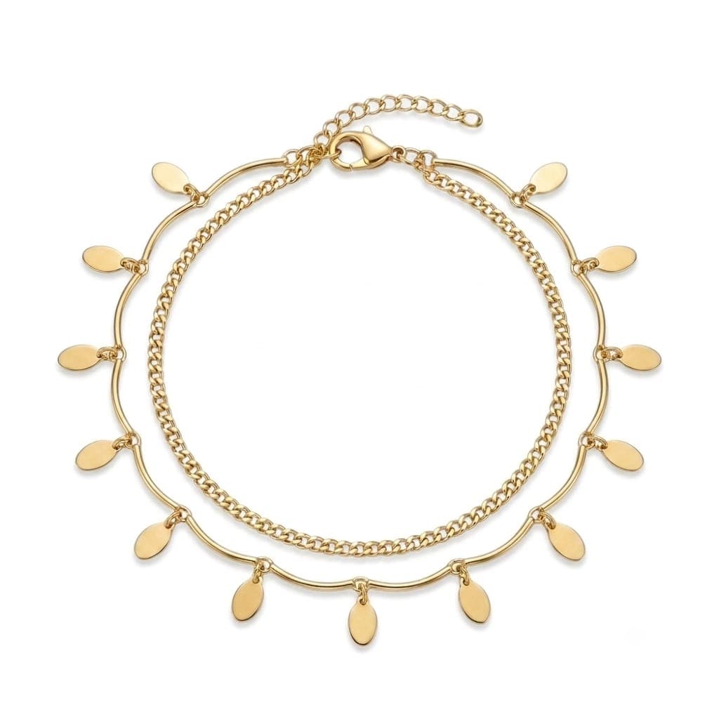 A luxurious anklet in an elegant gold color, with a double design combining a classic chain and another decorated with delicate oval pendants, with an adjustable clasp to suit you.