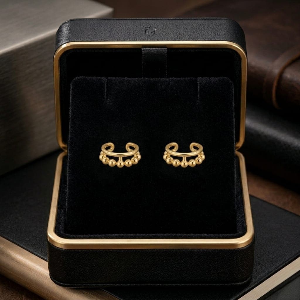 These distinctive gold earrings feature a row of prominent beads for an elegant and unique look. They require no piercing for easy wear and all-day comfort. Cuffs & Wraps (7)