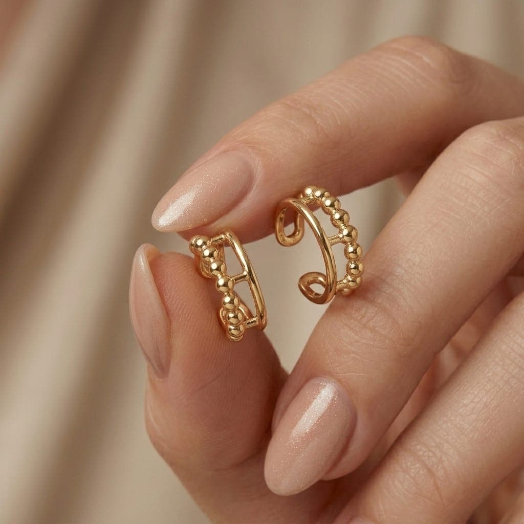 These distinctive gold earrings feature a row of prominent beads for an elegant and unique look. They require no piercing for easy wear and all-day comfort. Cuffs & Wraps (4)