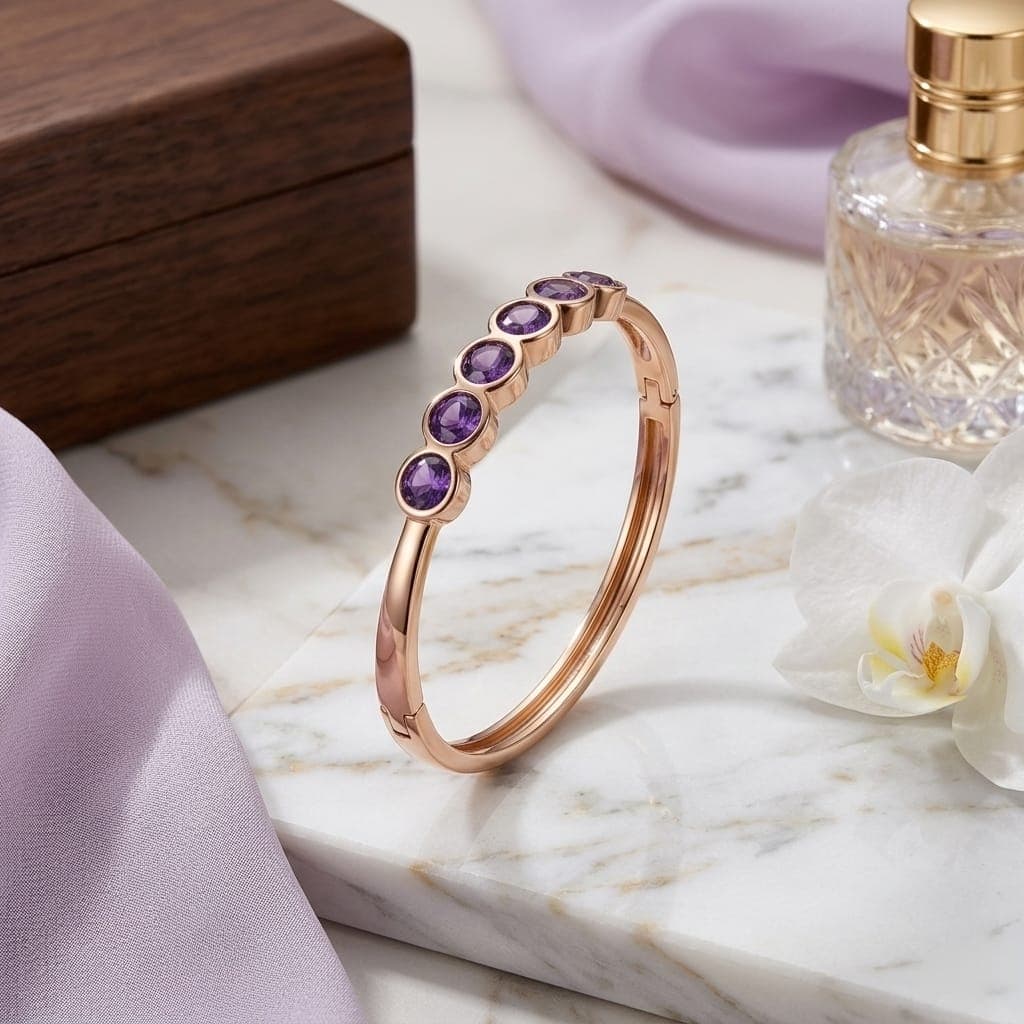 A luxurious bracelet in elegant gold, adorned with enchanting royal purple stones. It also features a side clasp, a streamlined design that will grace your wrist with an unforgettable touch of luxury. Women's Bangles (٧)