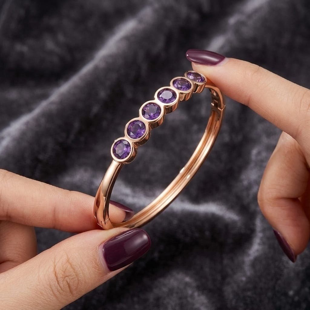 A luxurious bracelet in elegant gold, adorned with enchanting royal purple stones. It also features a side clasp, a streamlined design that will grace your wrist with an unforgettable touch of luxury. Women's Bangles (٦)
