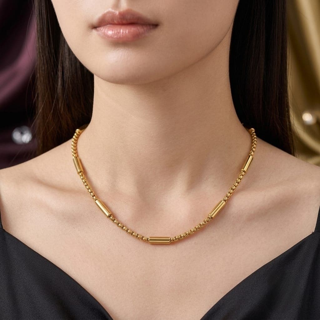A shimmering gold necklace with a unique, modern design, combining a classic chain style with the delicate elegance of sparkling cylindrical spacers. A touch of sophistication to complement your beauty! Women's Necklaces (٣)