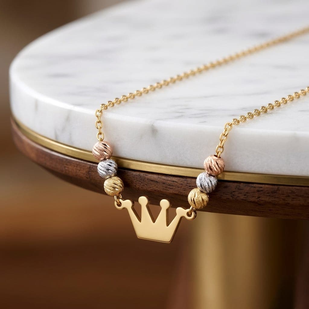 A regal necklace adorned with a gold crown pendant and colorful beads in a luxurious design, giving you a touch of elegance and distinction. It features an adjustable clasp for a perfect fit. Women's Necklaces (٥)