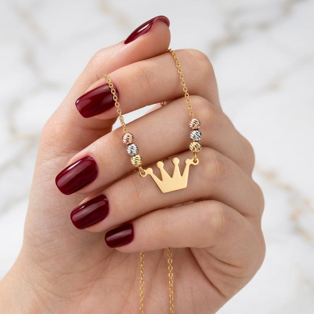 A regal necklace adorned with a gold crown pendant and colorful beads in a luxurious design, giving you a touch of elegance and distinction. It features an adjustable clasp for a perfect fit. Women's Necklaces (٤)