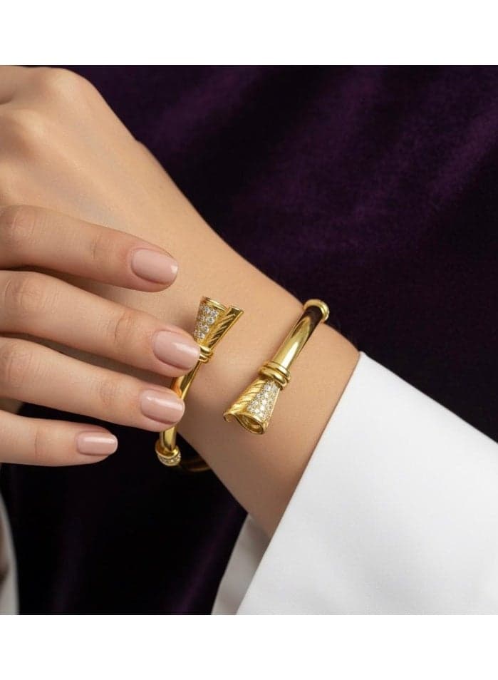 An open gold bracelet, adorned with two cone-shaped heads studded with sparkling zircon stones for an eye-catching shine with every movement. Women's Bracelets & Bangles (3)