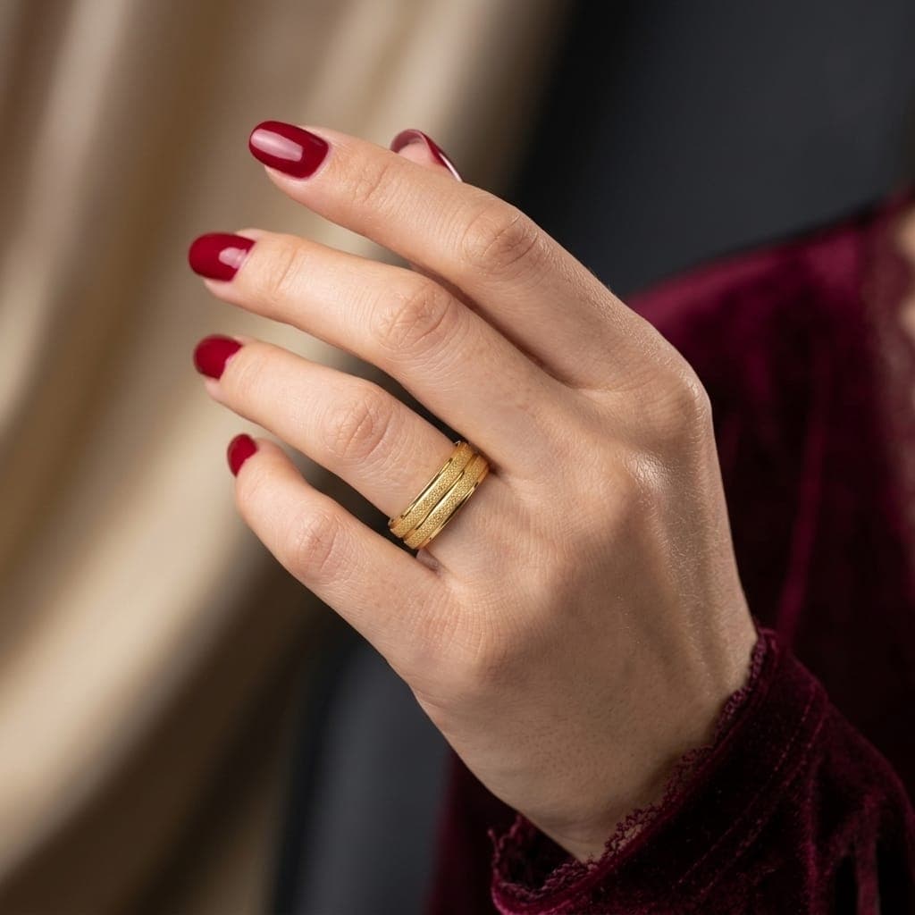 A unisex gold-tone ring, crafted from durable stainless steel, featuring a brilliant shine and sparkling details for an attractive look. Perfect for engagements and special occasions! Women's Rings (5)