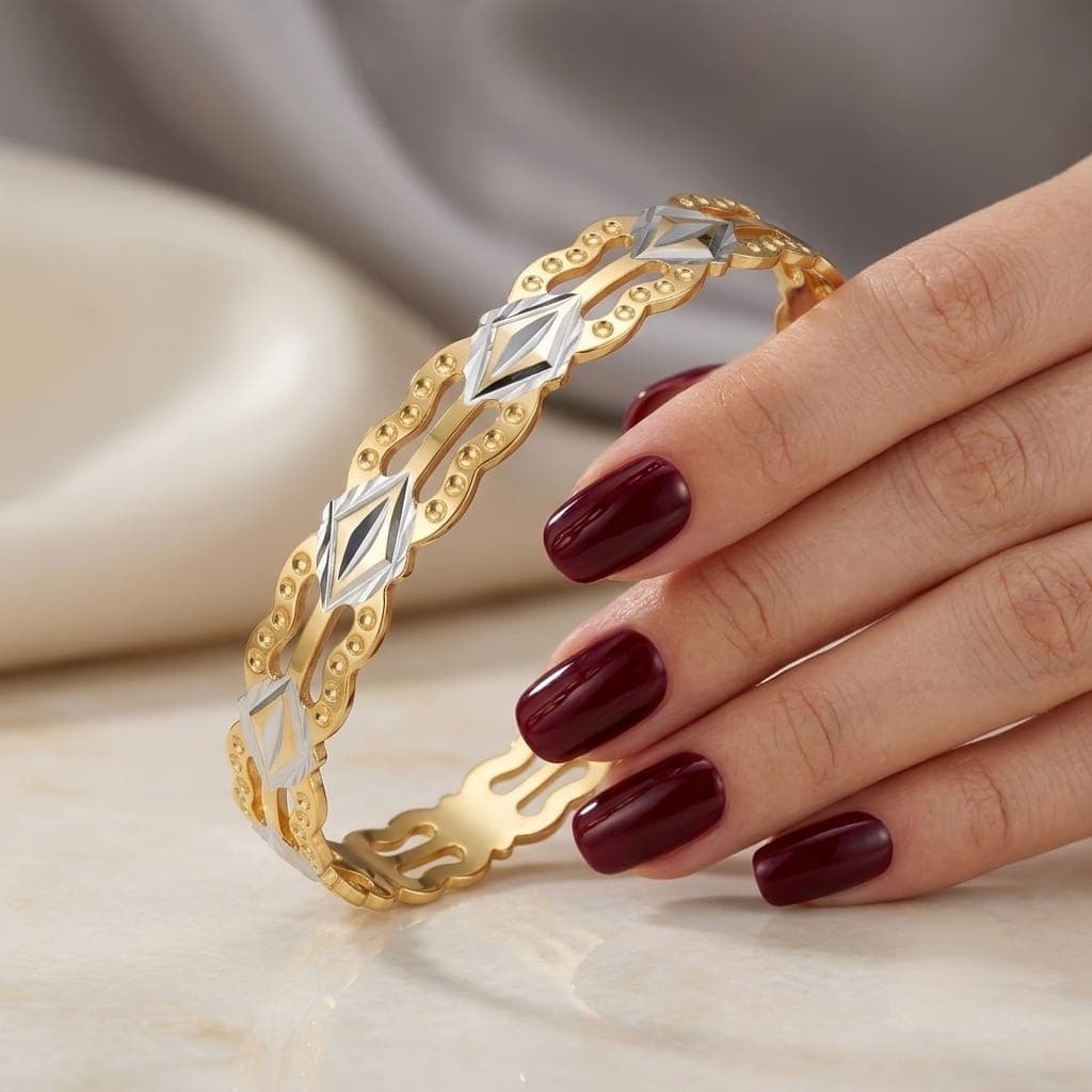 A luxurious bracelet in elegant gold, sparkling with wavy, openwork edges and attractive silver-colored geometric details that give you a charming and eye-catching modern look. Women's Bangles (4)