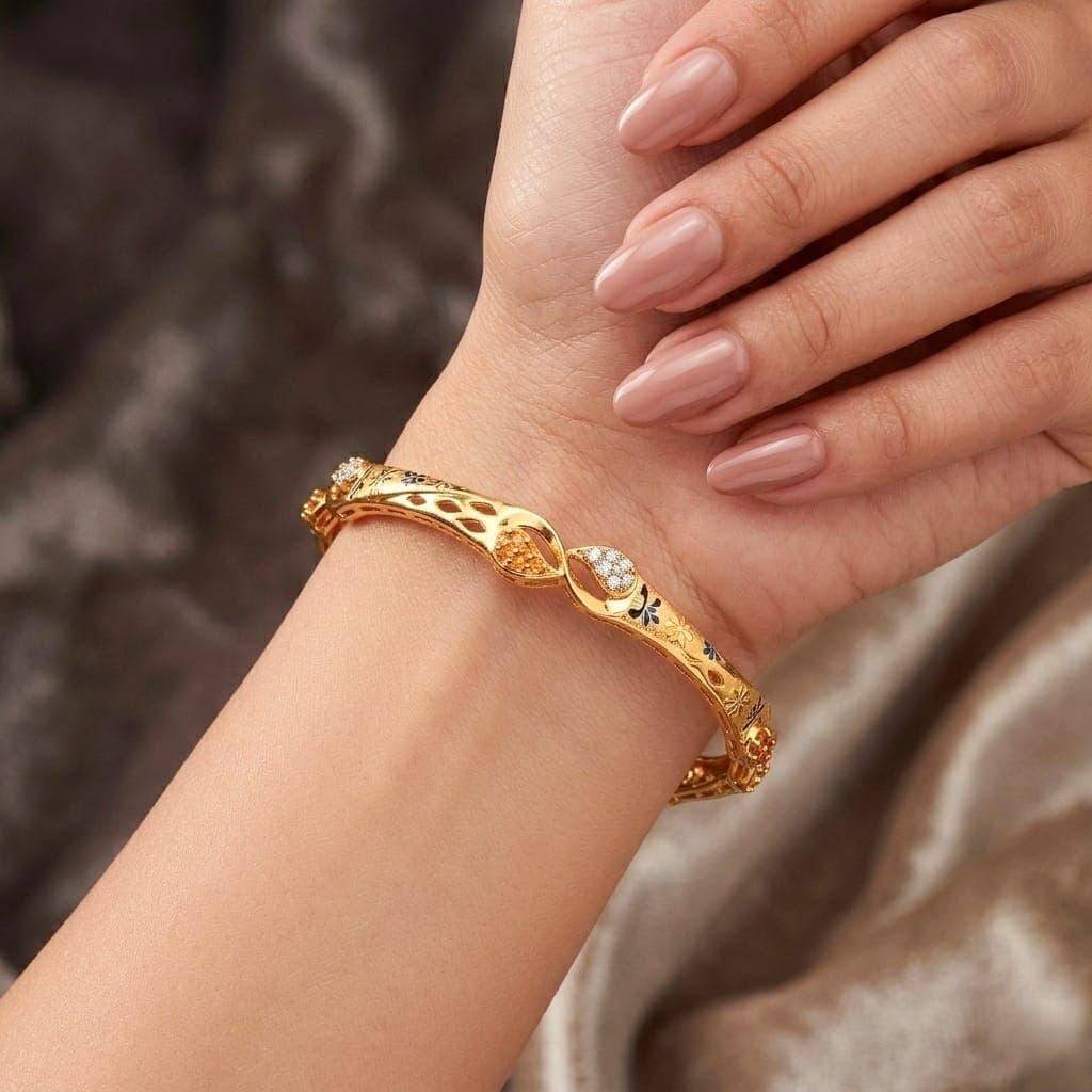 An elegant gold bracelet with a distinctive design that blends luxury and simplicity. Adorned with sparkling zircon stones and delicate engravings, it adds a touch of beauty to your look. Women's Bangles (3)