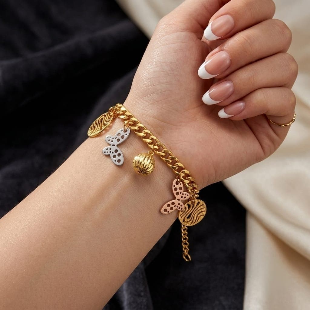 An elegant gold bracelet, decorated with silver and pink butterflies, a prominent gold ball, and attractive hollow circles with an adjustable clasp to fit you. Women's Bracelets & Bangles (٣)