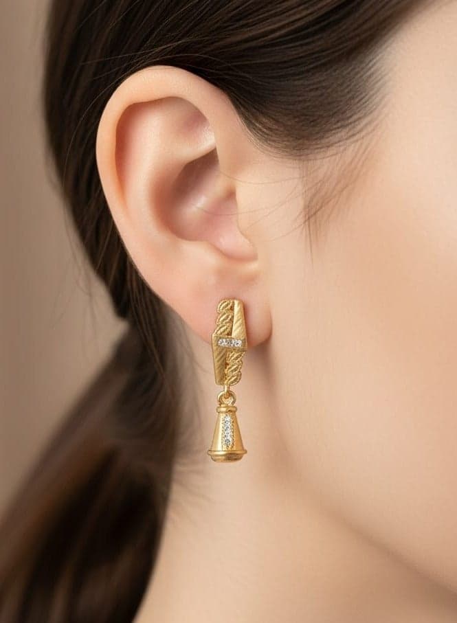 A delicate gold-plated hoop featuring an elegant wavy design, studded with sparkling diamonds and a charming bell-shaped pendant. Clip-Ons (2)