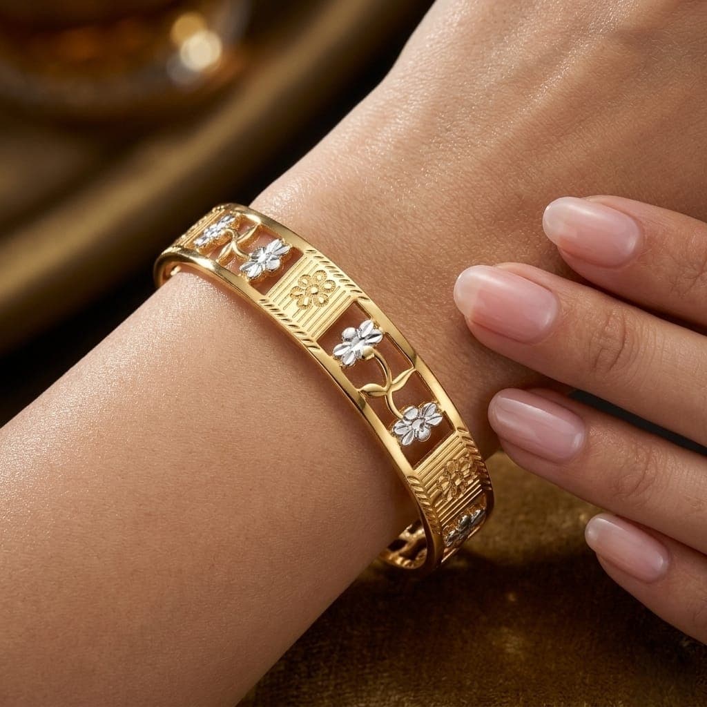 A luxurious gold bracelet with an elegant openwork design and delicate floral details that adds a touch of femininity and sophistication to your wrist. The perfect piece for a head-turning look. Women's Bangles (٢)