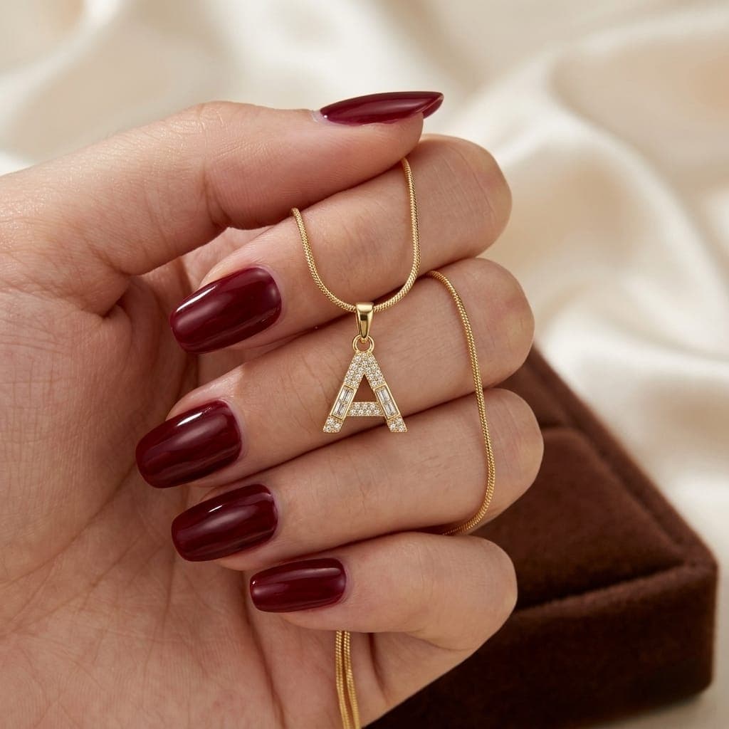 A luxurious, elegant gold necklace with a sumptuous letter A pendant studded with sparkling baguette and zircon stones, and an adjustable clasp to fit you. Women's Necklaces (٥)