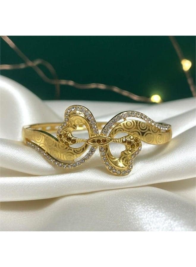 A gold bracelet with an open design, adorned with wavy patterns and sparkling crystals. It features a side clasp for a touch of luxury, suitable for any occasion. Women's Bracelets & Bangles (6)