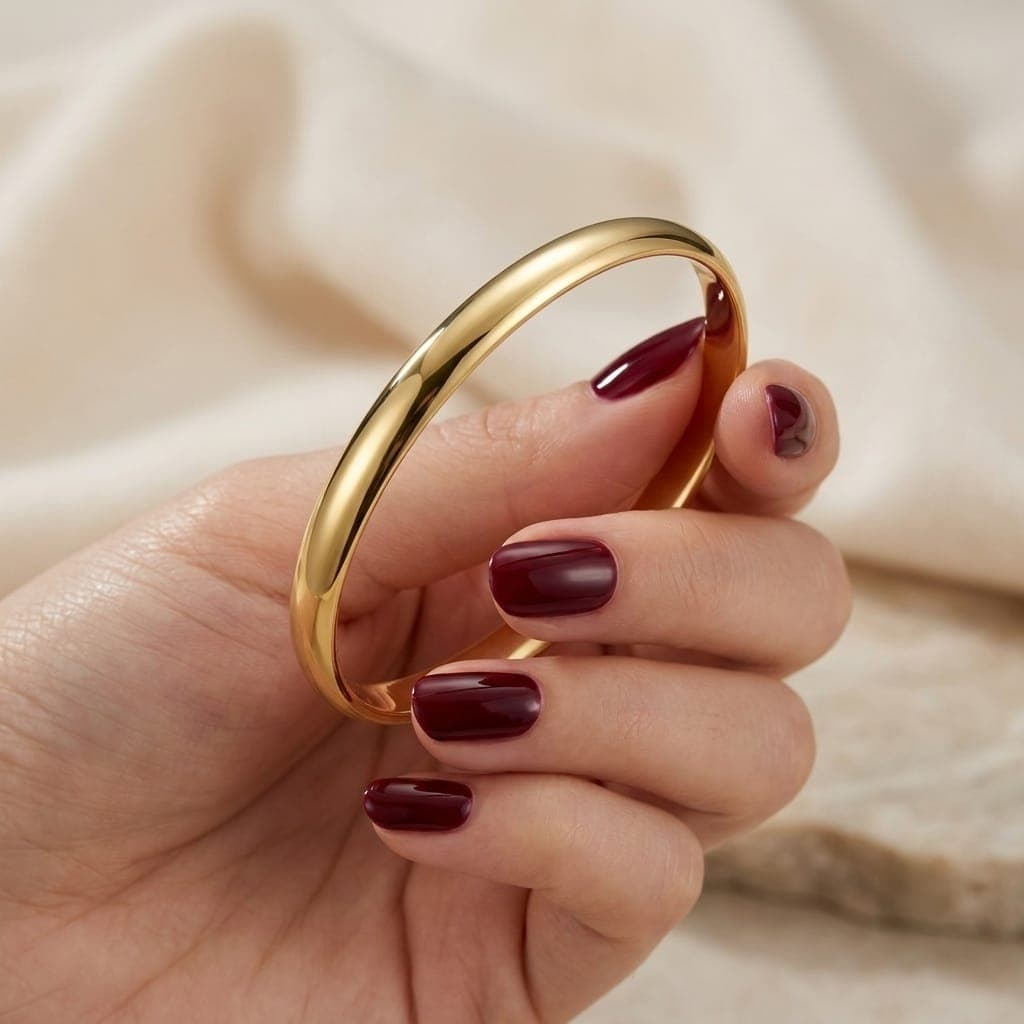 A luxurious, delicate gold bracelet with a classic, polished design that exudes smoothness and shine. Its simplicity adds a touch of sophisticated elegance to your wrist, complementing all your looks. Women's Bangles (5)