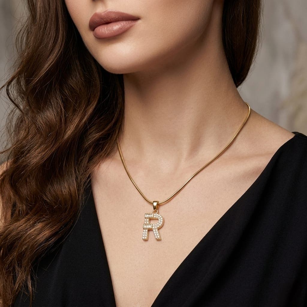 A luxurious, elegant gold necklace with a luxurious letter R pendant studded with sparkling baguette and zircon stones, with an adjustable clasp to fit you. (3)