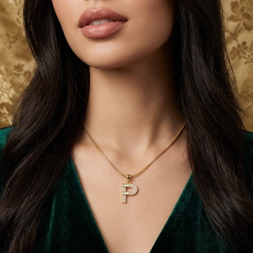 A luxurious, elegant gold necklace with a luxurious letter P pendant studded with sparkling baguette and zircon stones, and an adjustable clasp to fit you. (2)