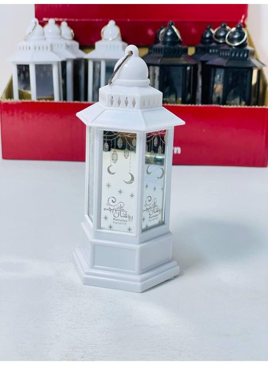 Imported plastic Ramadan lantern with LED lantern stand featuring Ramadan-themed designs and lights. The lantern is white and operates on batteries. Size: 13 cm Candle Lanterns