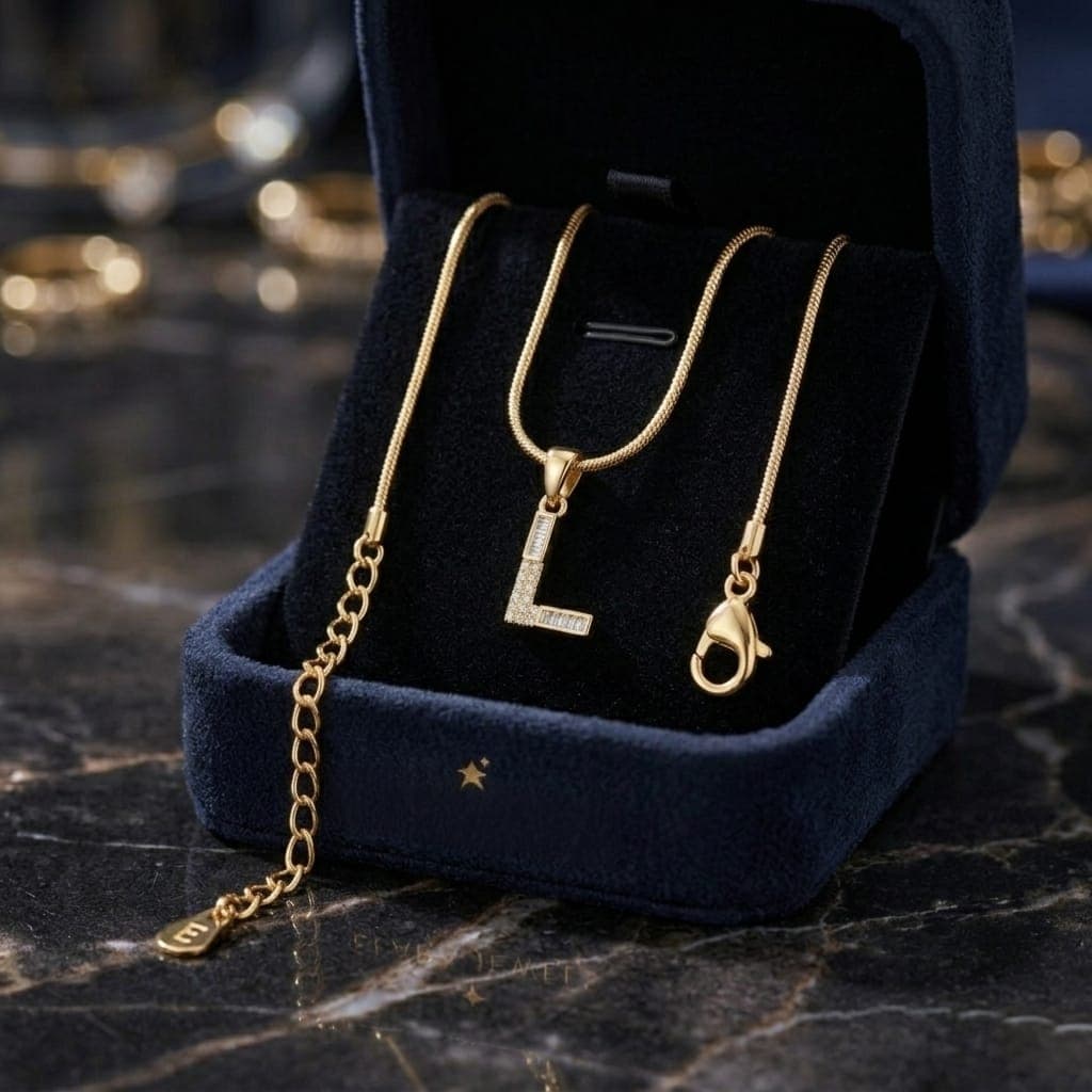 A luxurious, elegant gold necklace with a sumptuous L pendant studded with sparkling baguette and zircon stones, and an adjustable clasp to fit you. (6)