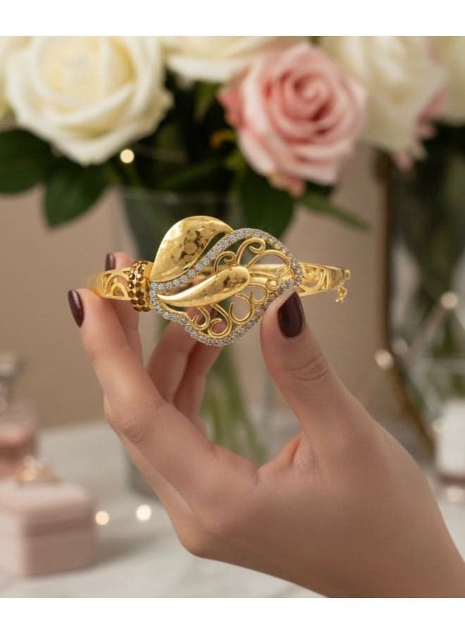 A luxurious gold bracelet with an elegant side clasp, featuring a wraparound open design and sparkling cubic zirconia. A masterpiece with a modern twist! Women's Bracelets & Bangles (٦)