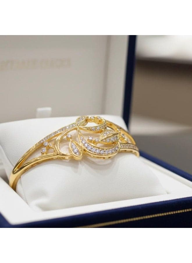 A gold bracelet with a side clasp, featuring an intricate Arabic design, expertly adorned with sparkling zircon stones. A captivating piece that blends classic elegance with modern sophistication. Women's Bracelets & Bangles (٥)