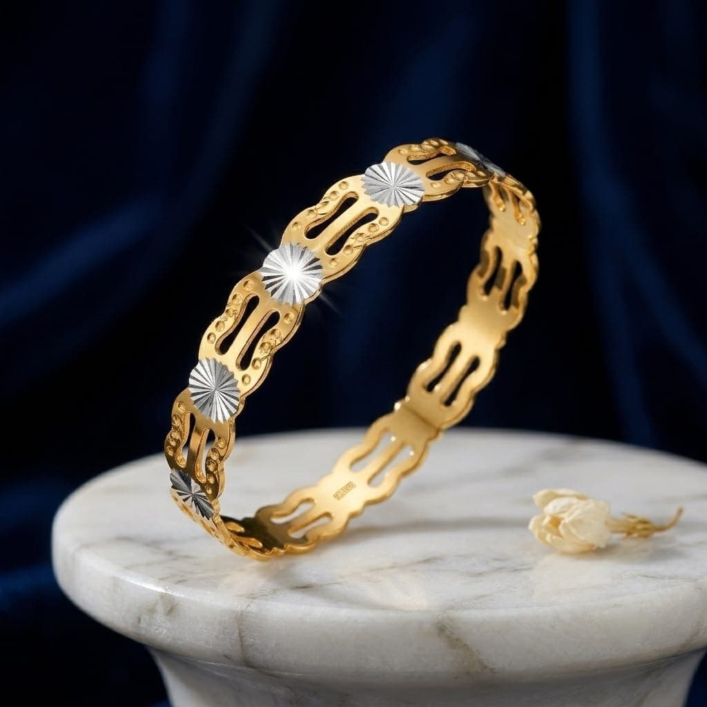 A luxurious bracelet in elegant gold, sparkling with shimmering silver details and intricate artistic cutouts. A modern design that will make your look stand out. Women's Bangles (٤)