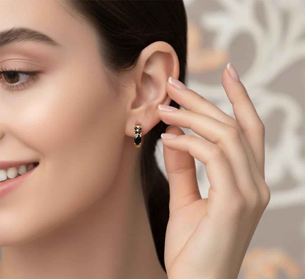 These gold earrings, adorned with regal black stones, combine elegance and luxury in a design that highlights a large oval stone topped with a delicate touch of beauty. A perfect piece to add a touch of sophistication to your look. Women's Earrings Hoop (٦)