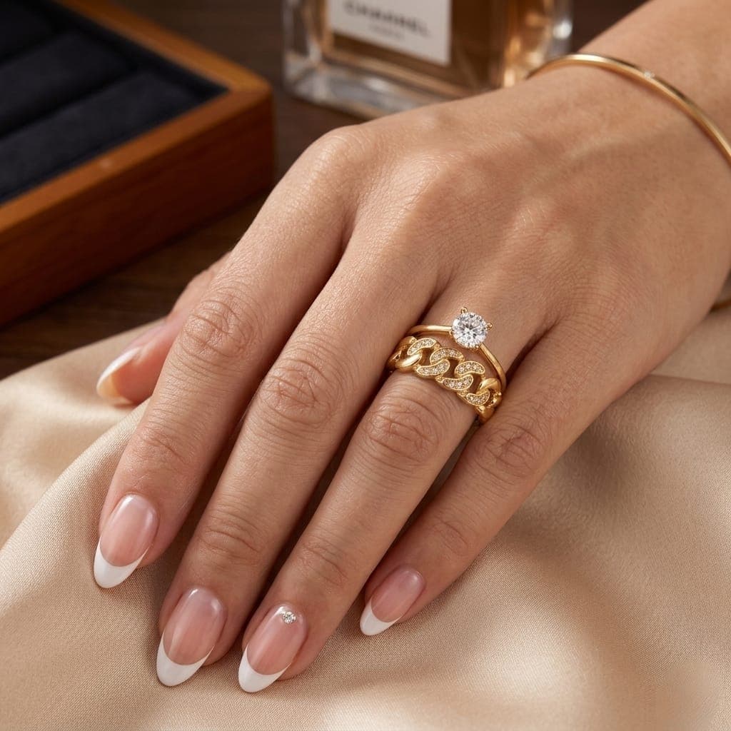 An elegant gold ring, with an interlocking chain design studded with sparkling zircon stones, featuring a prominent central stone to give you a luxurious and eye-catching appeal. Women's Rings (٣)