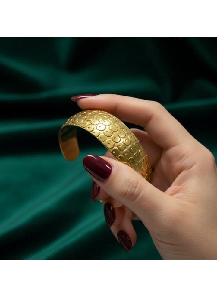 A children's open bracelet in a lustrous gold tone, featuring a raised pattern and delicate dotted details.nnA modern design that adds a touch of luxury to your little girl's wrist. Girls' Bracelets & Bangles (٣)