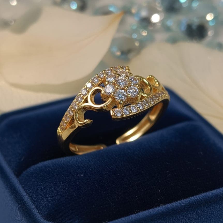 A luxurious gold ring with a zigzag pattern, set with two rows of sparkling cubic zirconia stones, and featuring a central cluster of cubic zirconia in a flower shape. Open to fit all sizes. Women's Rings (٤)