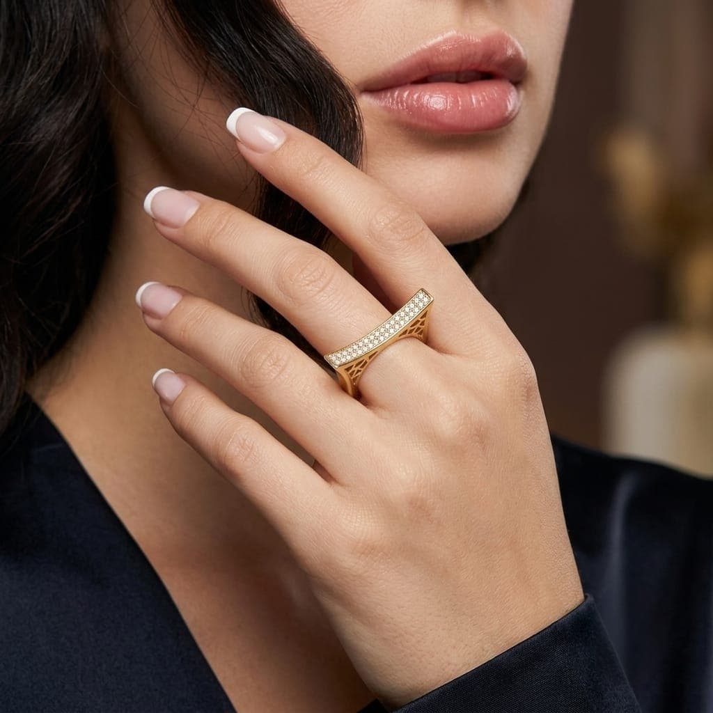 An elegant gold ring with a wide, curved band design sparkling with rows of brilliant zircon stones. It features geometric, openwork details on the sides, creating a unique and luxurious look that is sure to turn heads. Women's Rings (2)