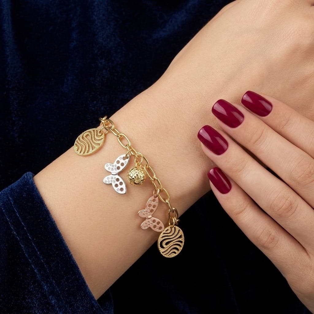 An elegant gold bracelet with luxurious clasp rings adorned with silver and pink butterfly pendants and attractive gold-colored hollow shapes, with an adjustable clasp to suit you. Women's Bracelets & Bangles (٢)