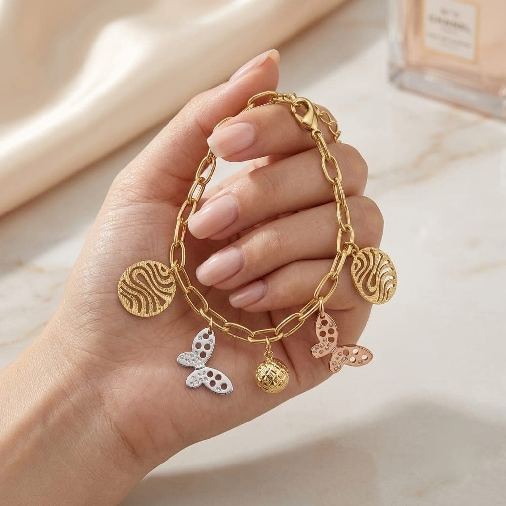 An elegant gold bracelet with luxurious clasp rings adorned with silver and pink butterfly pendants and attractive gold-colored hollow shapes, with an adjustable clasp to suit you. Women's Bracelets & Bangles (٦)