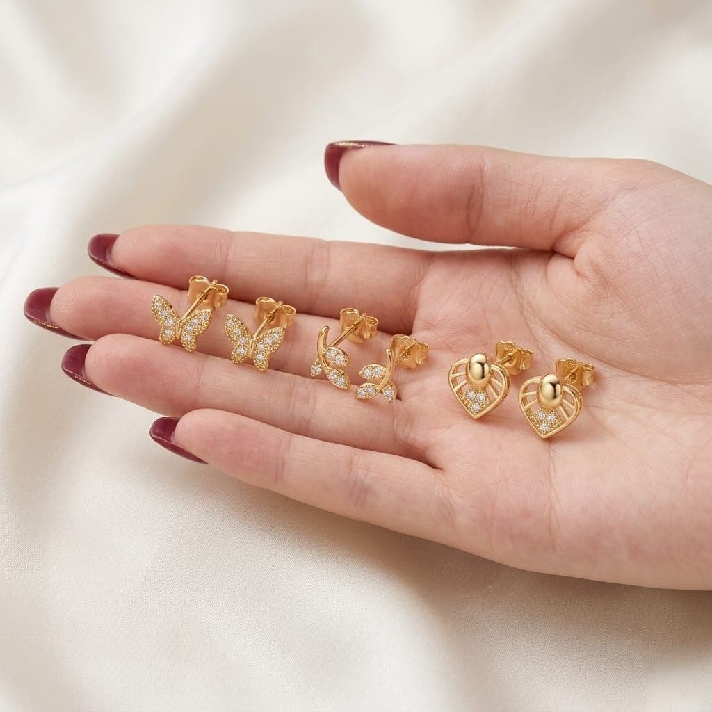 A set of 3 pairs of stud earrings in enchanting designs (butterfly, delicate branch, and sparkling heart) adorned with brilliant cubic zirconia stones. Shine with everyday versatility that combines luxury and elegance! Women's Earrings Stud (٤)