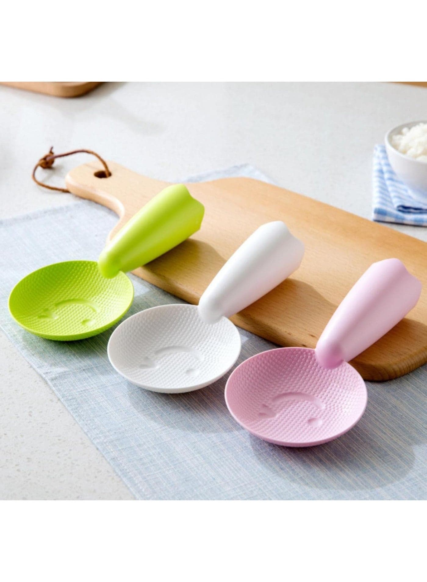 A plastic rice spoon in a smiley shape, perfect for serving food in your everyday kitchen; a practical and durable design. Spoons & Spoon Sets