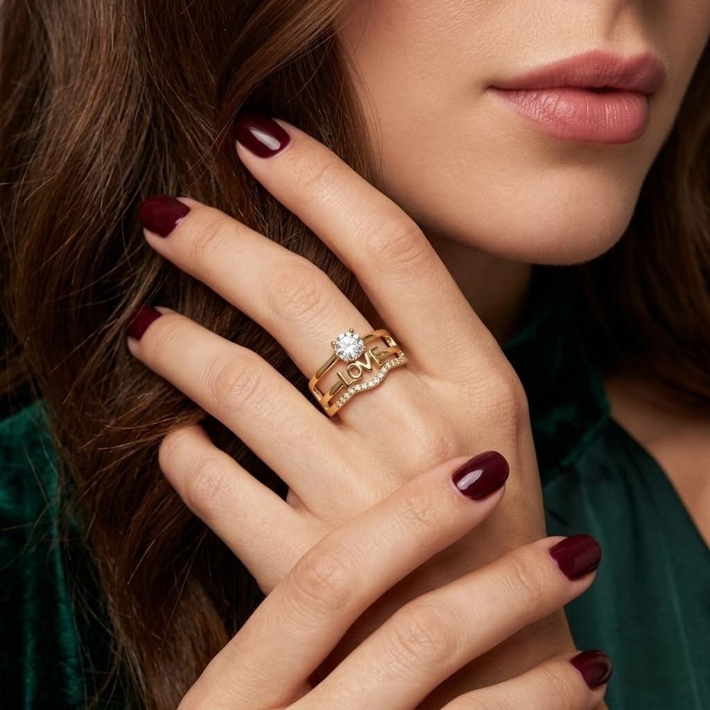 An elegant gold ring with a connected design that expresses love. It features the word "LOVE" prominently displayed, with a sparkling cubic zirconia stone above it and a band adorned with brilliant pavé cubic zirconia stones. Women's Rings (2)