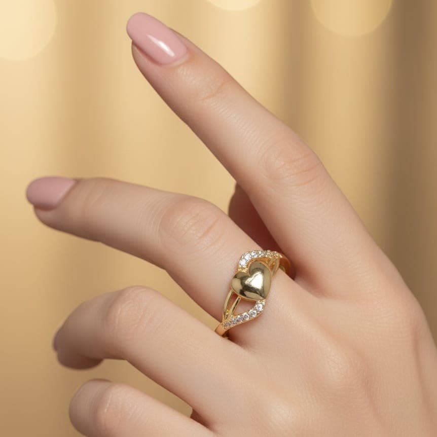 A luxurious gold ring featuring a prominent heart design, adorned with two flowing rows of sparkling cubic zirconia stones. Open to fit all sizes. Women's Rings